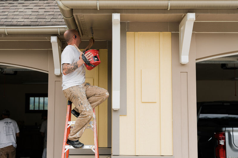 Residential exterior being painted by a professional painter.