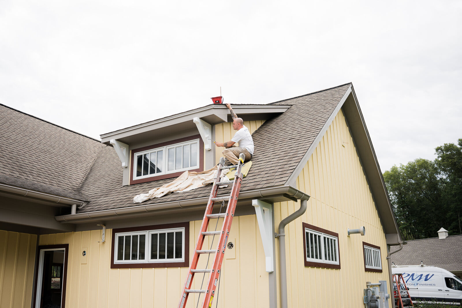 Residential exterior being painted by a professional painter.