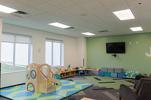 Green kids room at a church with playset.