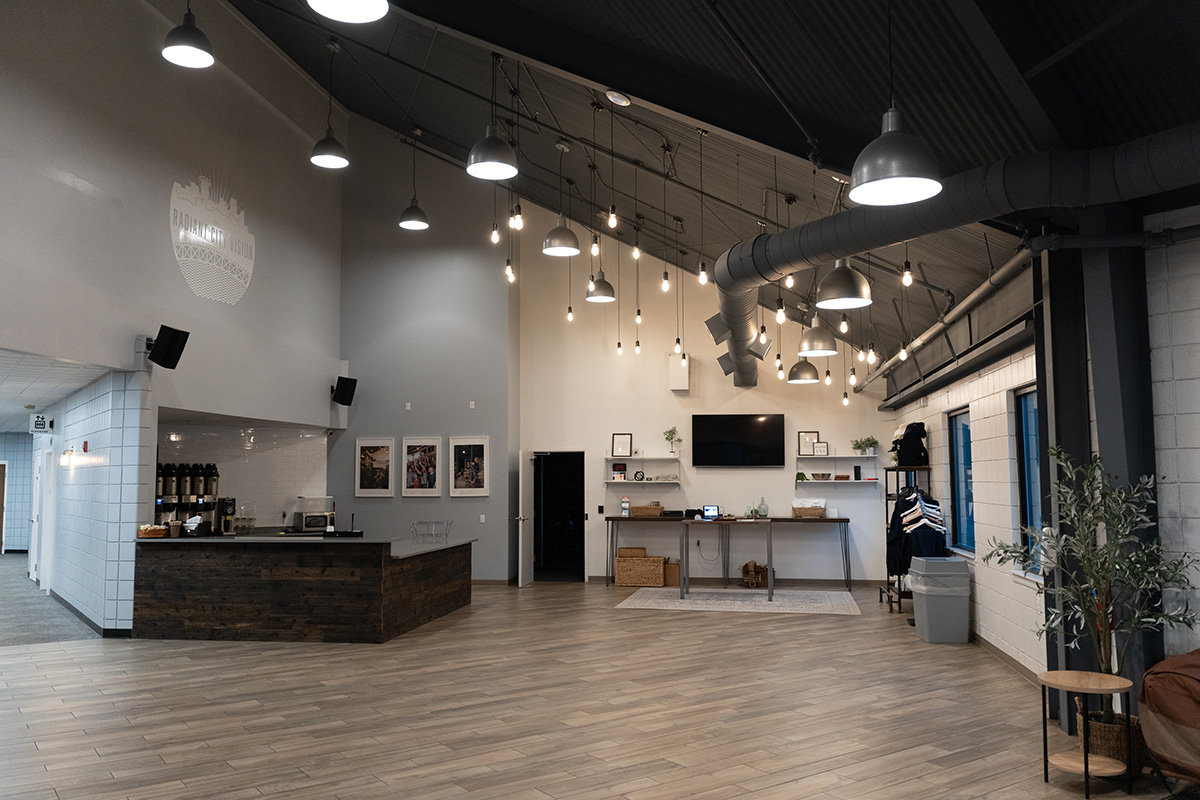 Lobby of a church with string lights and coffee bar.