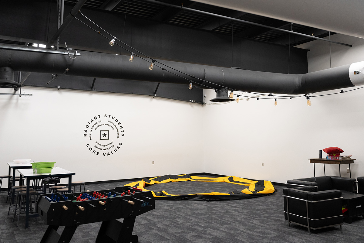 Youth room at a church with white walls and gray ceilings and floors.