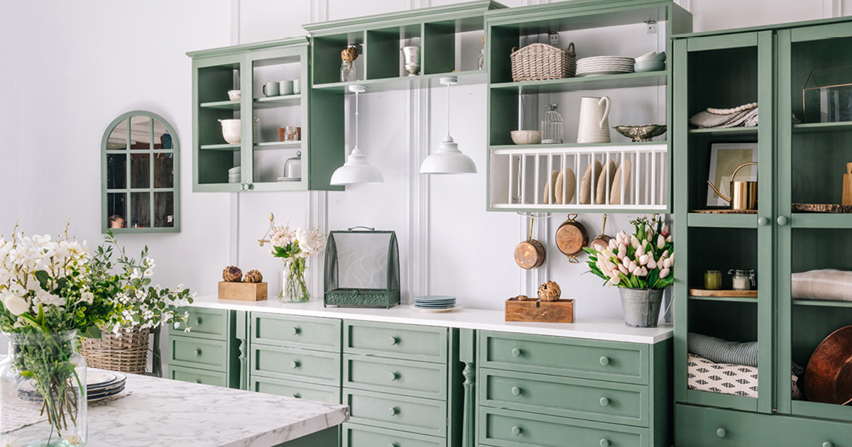 PMV - Blog - How To Choose A Kitchen Cabinet Color Header Cottage style kitchen with green cabinets and white countertops.