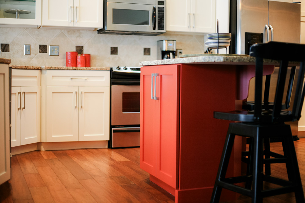 PMV - Blog - Top 10 Kitchen Cabinet Colors 2024 1 Freshly painted kitchen cabinets with white cabinets and a red island