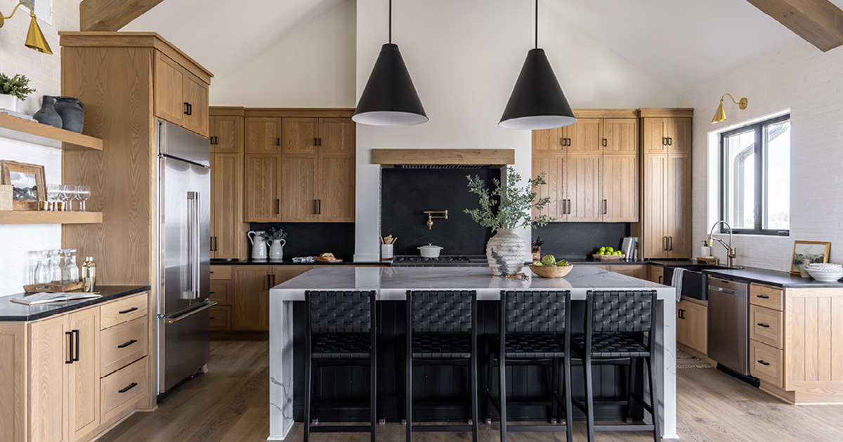 PMV - Blog - Wood Kitchen Cabinets Are Back Header Kitchen with light wood cabinets and a stone island