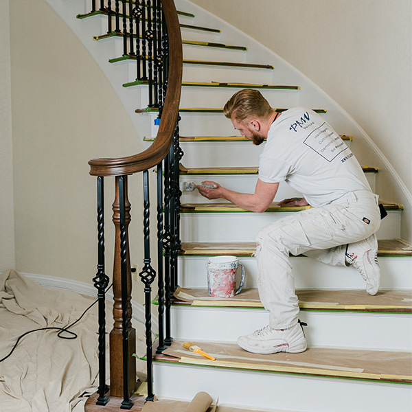 PMV - Project Highlight - Lake Templene Entry 1 PMV Painting employee painting stair risers white.