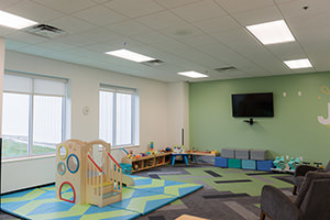 PMV - Project Highlight - Radiant Church Kids Rooms 3 Green kids room at a church with playset.