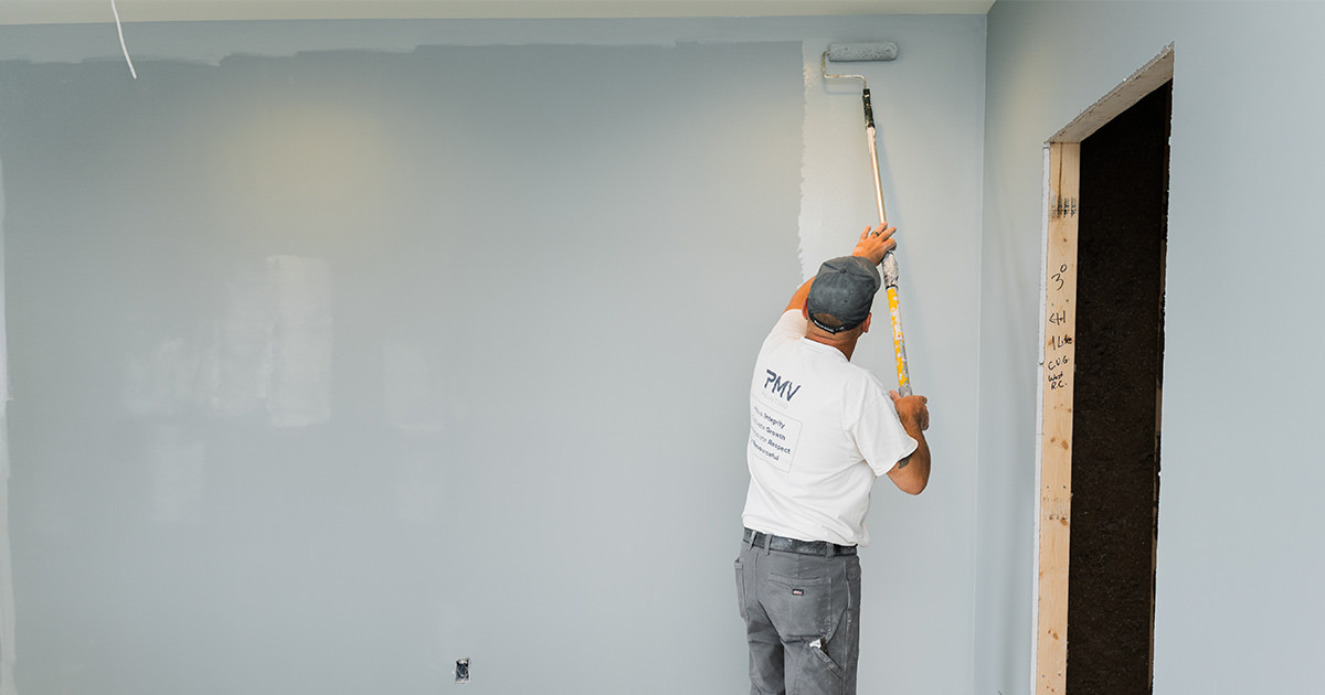 PMV Painting painter rolling paint onto a wall in Kalamazoo, MI