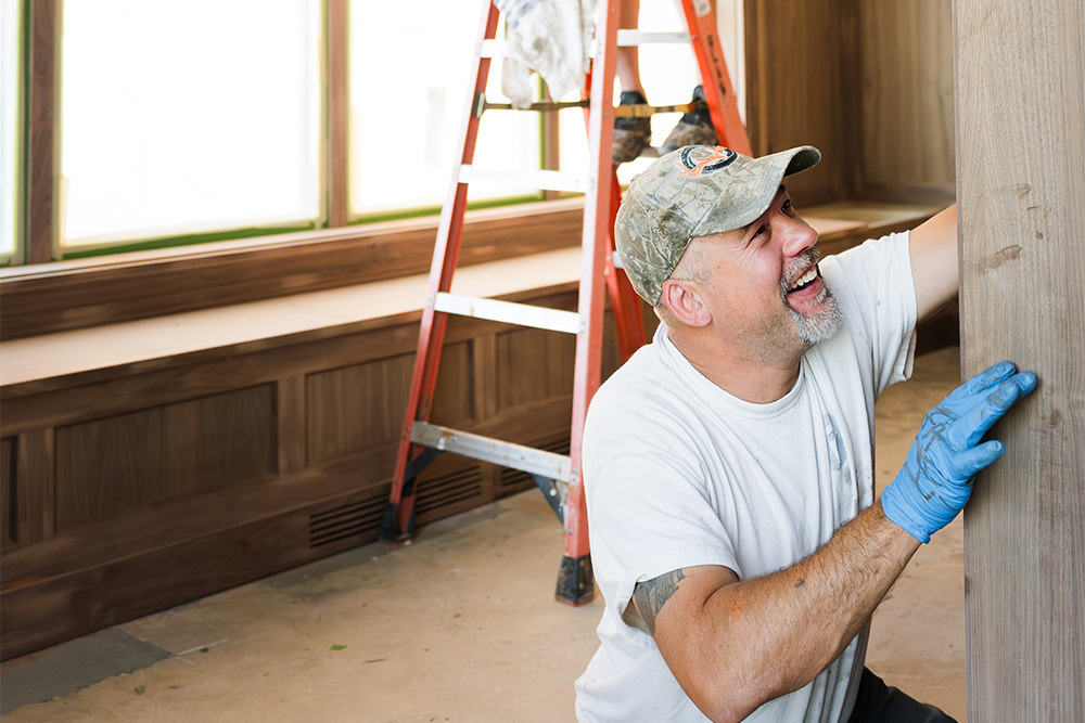 PMV Painting painter staining a wooden bookcase in Kalamazoo, MI