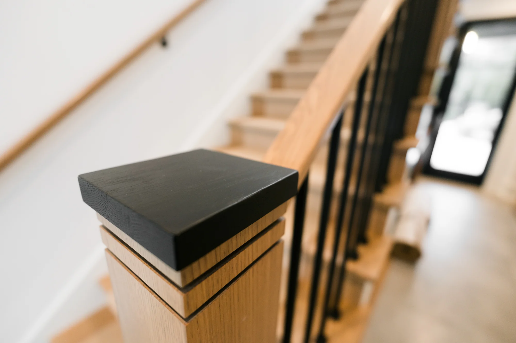 Close-up of staircase railing and trim with smooth painted finish and clean transitions in Kalamazoo home