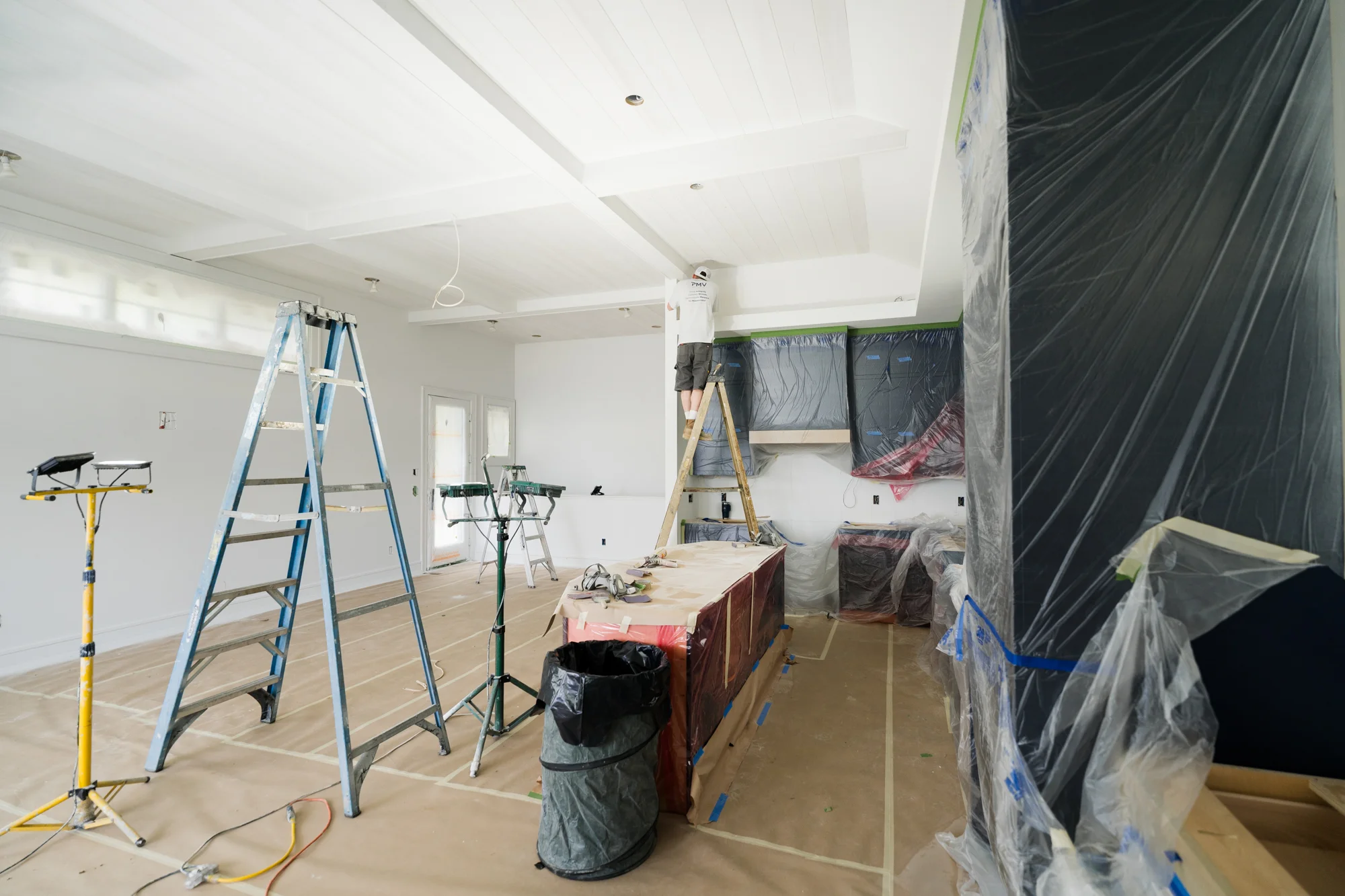 PMV Painting team following safety protocols and protecting surfaces during a commercial painting project.